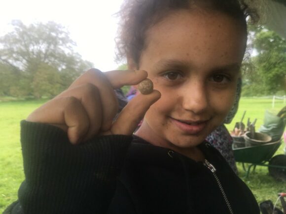 Hannah with a musket ball. Image courtesy of Dig Ventures.